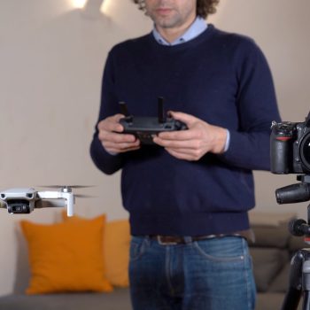 A photographer uses a drone for surveying, photography and video of apartment indoor and building interiors - real estate and home staging for sell the home - new 4k aerial technology
