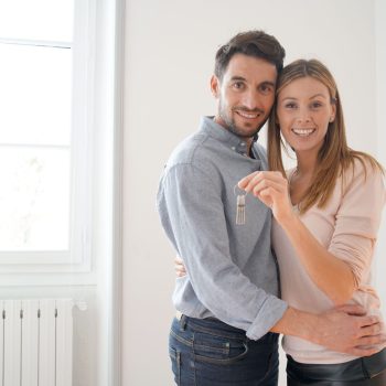 Happy couple with keys to new home